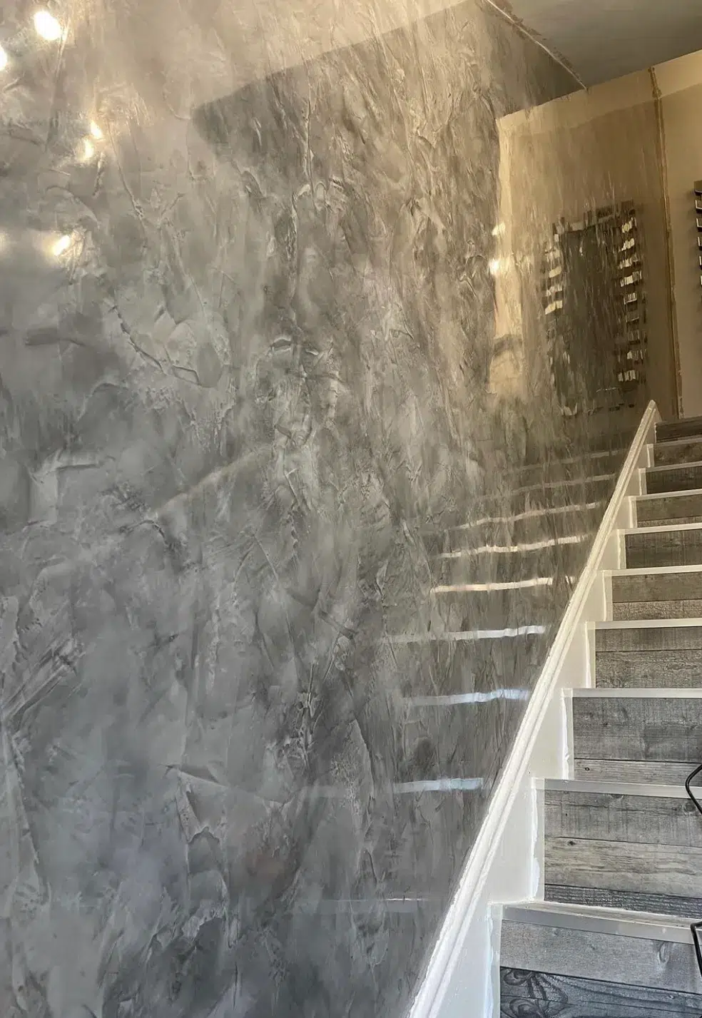 Image of Stair Wall finished with Decoveno Dark Grey Venetian Plaster