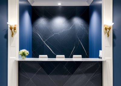 Image of a modern reception area with black Venetian Plaster desk and walls