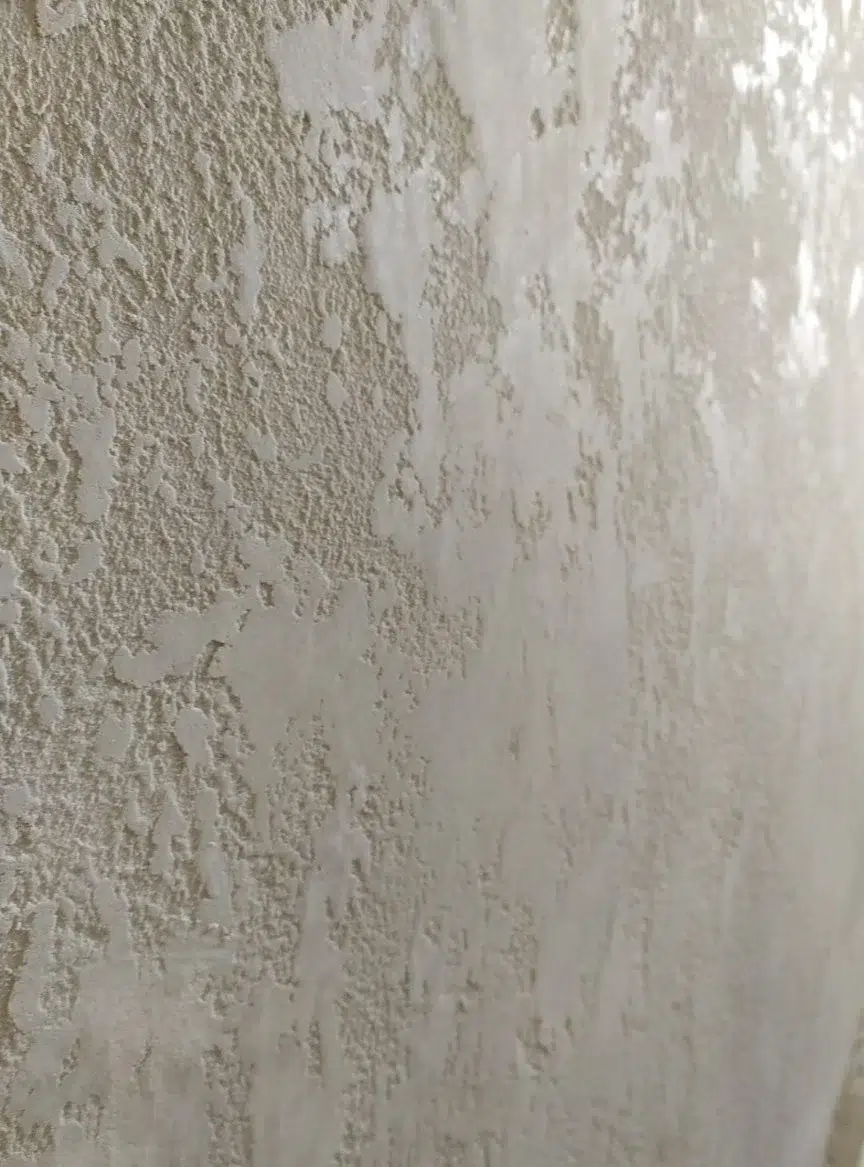Pitted Travertine Concrete Effect reference showing irregular pits and smooth compressed areas in a light stone-grey surface